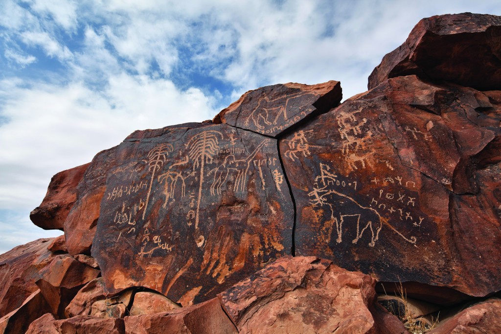 This petroglyph panel at Jabal Yatib was shallowly scratched through the dark desert varnish.  The subjects (lion, palm trees, camels, horses, and writing), as well as the technique, indicate that it was done after the Holocene Wet Phase.